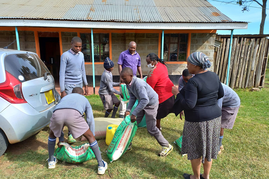 donating maize flour to school children
